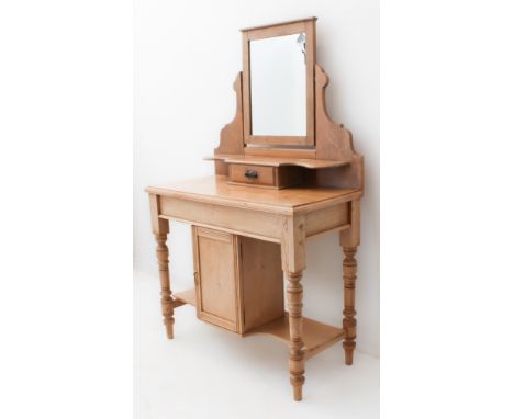 An early 20th century mirror-topped pine dressing-table: small central drawer to mirrored superstructure and single panelled 