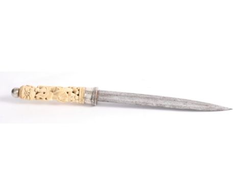 An Indian/Malaysian dagger with steel blade and silver ferrule, the carved ivory handle formed as two mythical creatures, 15"