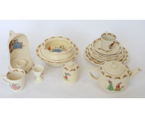 Seventeen pieces of Royal Doulton "Bunnykins" nursery tea wares including a candle holder, a teapot, a hot dish and various p