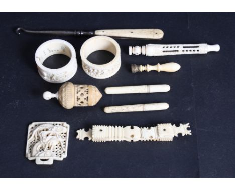 A pair of Chinese carved and pierced ivory napkin rings, a vegetable ivory thimble case and a number of other carved ivory an