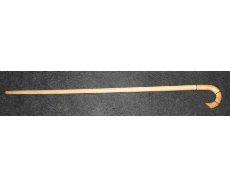 A walking stick with ivory handle and bone shaft, 32" high