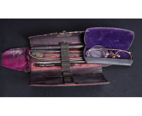 A set of Victorian surgeon's tools, in fitted tooled and gilt leather wallet, and a pair of rolled gold pince-nez, in fitted 