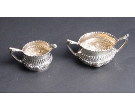 A silver cream jug and sugar basin with embossed decoration, 4.4oz troy approx