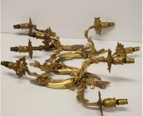 Two pair of gilt brass two-light wall brackets of Rococo design