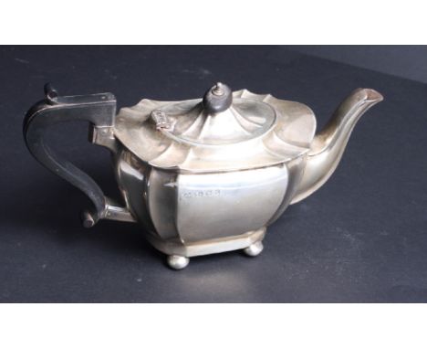 A silver teapot of Georgian design with ebonised handle, 12.3oz troy approx