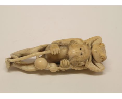 A 19th Century Japanese carved ivory okimono of a baboon with walking stick and gourd and toad riding his shoulders, 4" high 