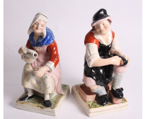 A pair of continental ceramic figures of seated peasants, 13" high