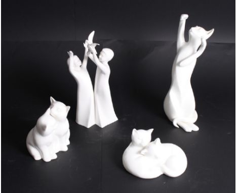 Three Royal Doulton bone china models of cats and a similar figure of two ladies, "Freedom"