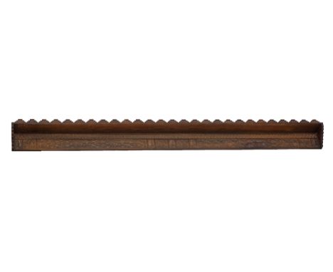 A Cypriot carved stained pine wood wall shelf, a carved plank supporting the shelf with a stepped corner to each end, the she