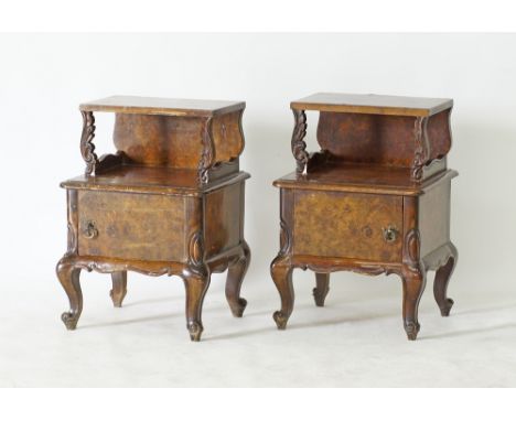 A Cypriot pair of ornate bed side cabinets, carved and veneered in burr walnut, in two tiers with cupboard below a shelf, on 