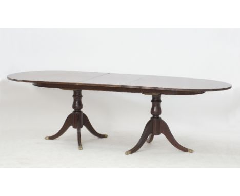 A Cypriot Savvides c1960s Regency-style extendable mahogany double pillar dining table, the semi circular end top with reeded