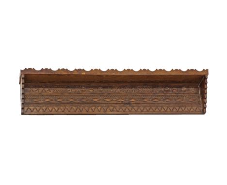 A Cypriot carved stained pine wood wall shelf, a carved plank supporting the shelf with a stepped corner to each end, the she