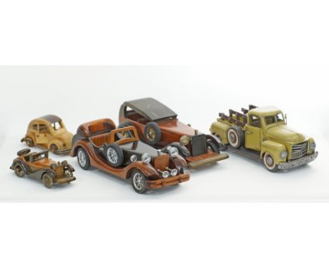 A collection of vintage toy car models, one tin van L32cm, two large wooden L37cm and two small wooden L19cm and L20cm. (5)Συ