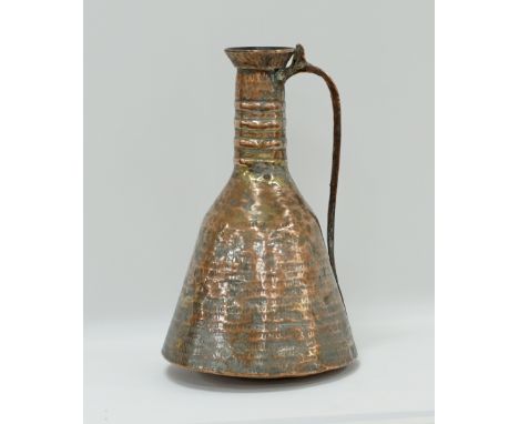 A Middle Eastern / Persian tinned copper ewer / pitcher with handle, hammered with a flaring long neck with four repoussé rin