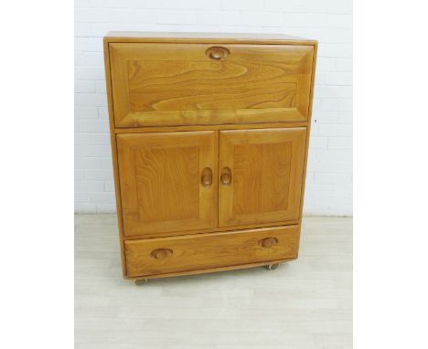 Ercol Golden Dawn, Windsor range bureau cabinet with a fall front over a pair of cupboard doors, with a drawer to the base, 1