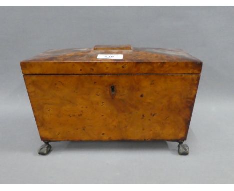 19th century walnut sarcophagus tea caddy, the hinged lid opening to reveal two lead lined divisions, on hairy paw feet with 