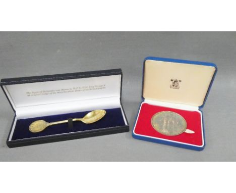 The British Empire Spoon, a silver gilt commemorative teaspoon and a Royal Mint silver QEII 25th anniversary coronation medal
