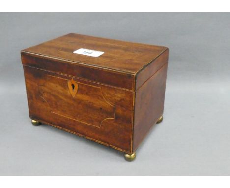 19th century mahogany and inlaid tea caddy with hinged lid and two divisions, on four brass bun feet, 18 x 12cm 