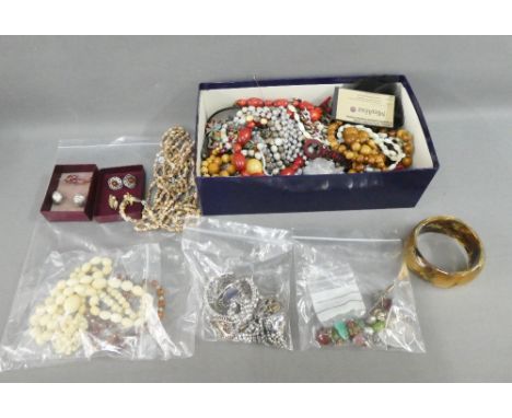 A quantity of silver and costume jewellery to include lockets, beads and bangles, etc,  together with jade earrings (a lot) 