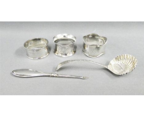 Three early 20th century silver napkin rings, silver handled nail file and a Sheffield silver sifter spoon (5) 