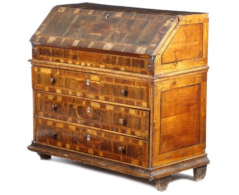 An 18th century continental walnut and fruitwood bureau, crossbanded and inlaid with cedar cartouches, the hinged fall reveal