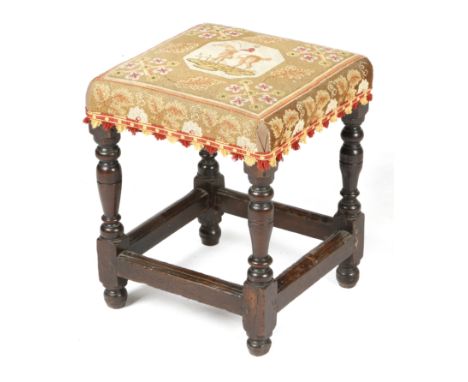 A Charles II upholstered oak stool, later covered with 19th century needlework depicting a horse and rider, on turned legs un