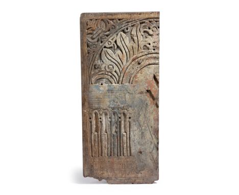 A rare oak and polychrome decorated panel fragment, carved with leaves and a stop fluted column arch, late 16th / early 17th 