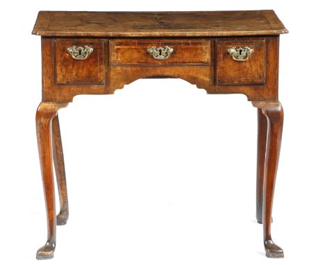 A George II walnut lowboy, cross and feather banded, the quarter veneered top with a full caddy moulded edge and with re-entr