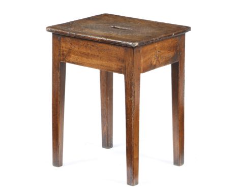 An early 19th century elm stool, the rectangular seat pierced with a handgrip, 50.4cm high, 39.7cm wide, 33.2cm deep. Provena