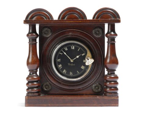An early 19th century mahogany watch stand, inlaid with stringing and brass mounts, the triple arched top above baluster ring
