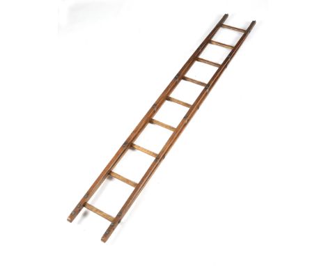 A pine ladder by Hattersley &amp; Davidson, with nine treads, the base with iron mounts and spikes, stamped 'HATTERSLEY &amp;