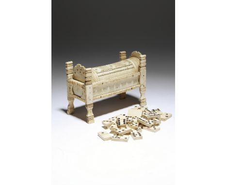 An early 19th century French Napoleonic bone prisoner of war games box, in the form of a bed, the lid pierced with holes for 