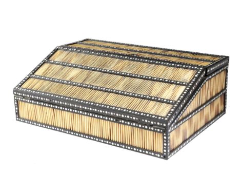 λ A late 19th century Ceylonese ebony and porcupine quill writing slope, with ivory and bone dot inlay, the hinged top reveal