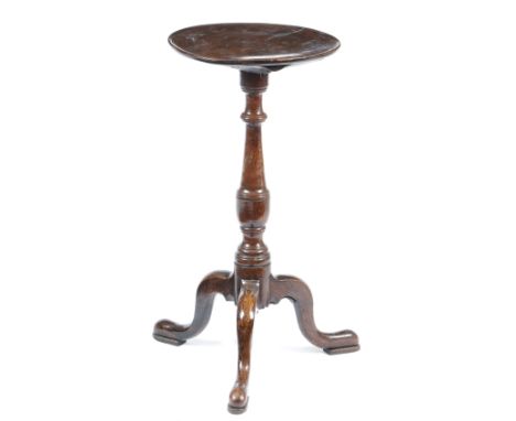 A George II oak lamp stand, the fruitwood dished circular fixed top, on a vase turned stem, on tripod supports and pad feet, 