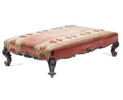 λ A large Victorian rosewood stool, the seat covered with plush fabric and tapestry, the frame carved with leaves and scrolls