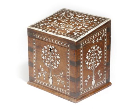 λ An Anglo-Indian hardwood tea caddy, inlaid with bone and ivory with urns of flowers and leaves, with brass mounts, the slop