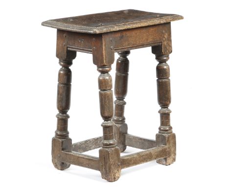 A mid-17th century oak joint stool, the seat with a moulded edge, the frieze branded with owner's initials 'W R', on turned s