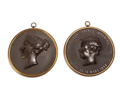 A pair of Victorian bois durci portrait relief rondels, of Queen Victoria and Napoleon III, both titled, in gilt brass frames