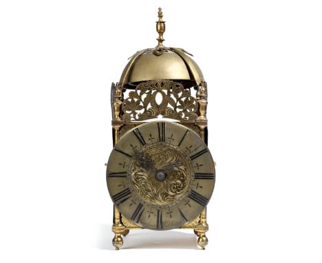 A brass lantern clock, the eight day brass twin fusee movement with an anchor escapement and striking on a bell, with a circu