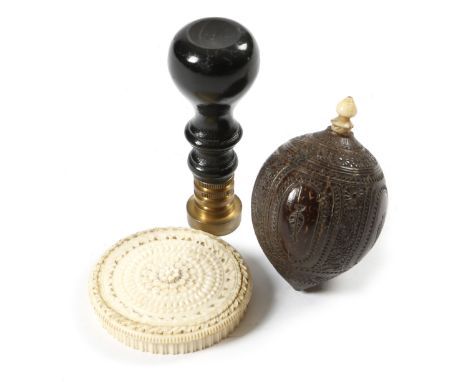 λ A Victorian machine turned ivory disc box, with a rose turned lid, together with a seal with an ebonised handle, the brass 