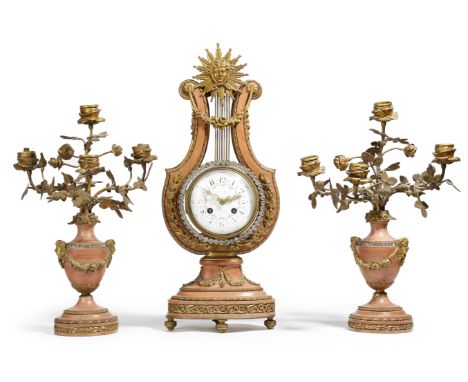 A late 19th century French pink marble and ormolu clock garniture in Louis XVI style, the lyre shape clock with an eight day 