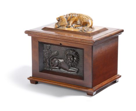 A Victorian folk art mahogany box, the hinged lid with a carved maple model of a spaniel, with a vacant interior, the front w