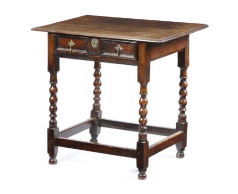 A William and Mary oak side table, the top with a moulded edge, above a twin panelled front frieze drawer, one side rail with