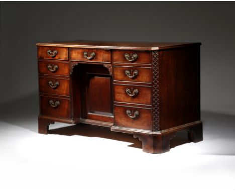 An early George III mahogany kneehole desk, the moulded edge top with part crossbanding and inlaid with ebonised stringing, a