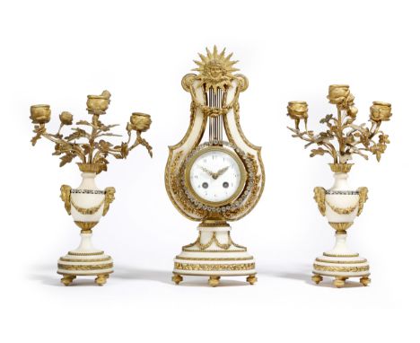 A late 19th century French white marble and ormolu clock garniture in Louis XVI style, the lyre shape clock with an eight day