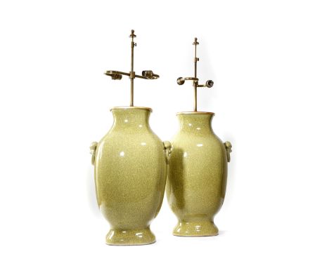 A pair of large pottery crackle glaze table lamps in Chinese style, each with twin lights and with lion's mask ring handles, 