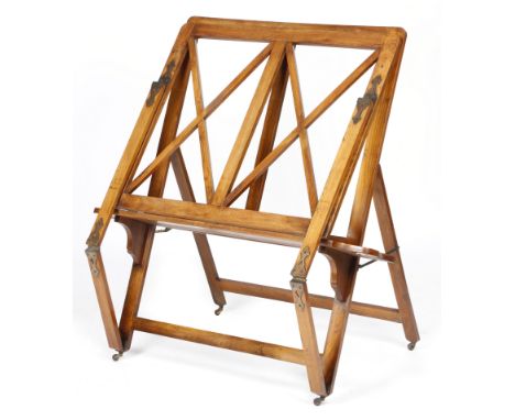 An Edwardian Scottish walnut folio stand by Wylie &amp; Lochhead, with brass strapwork hinges and 'X' frame supports, on cera