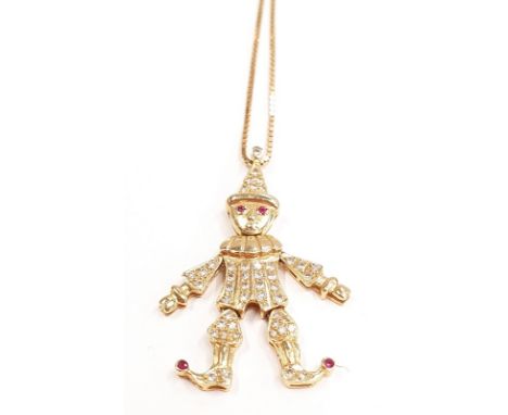 18ct gold diamond clown pendant with ruby eyes.