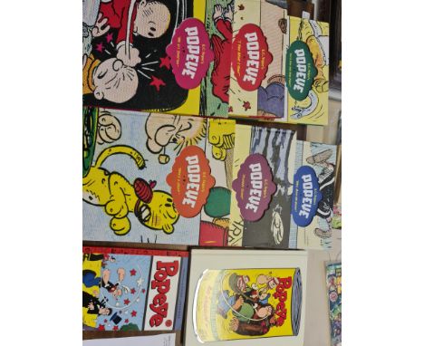 A six large Popeye carton books and together with a volume featuring the best of the Bud Sagendorf stories and Volume 1 of th