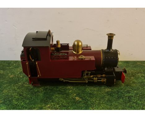 A gauge 1 model train engine red and black.